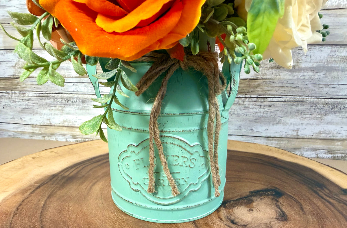 Orange & Yellow Floral Arrangement in Teal Metal Bucket